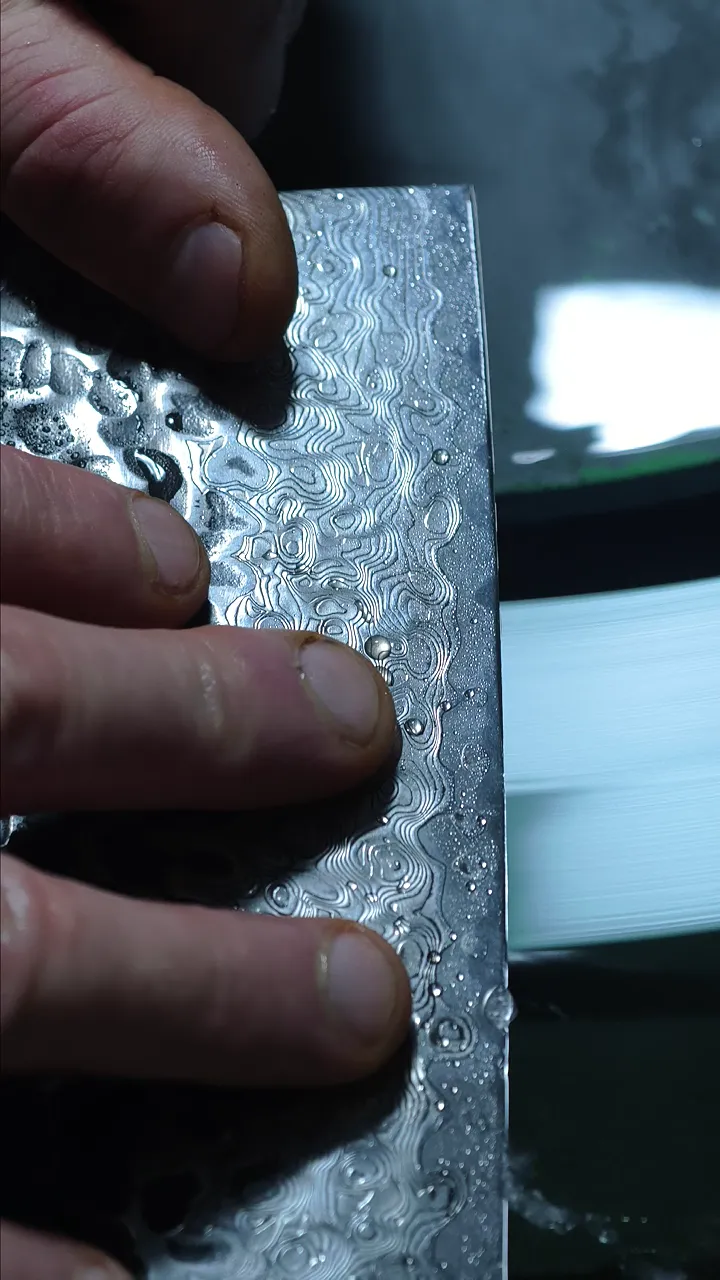 Close-up of a Damascus blade surface in Jacob's hand