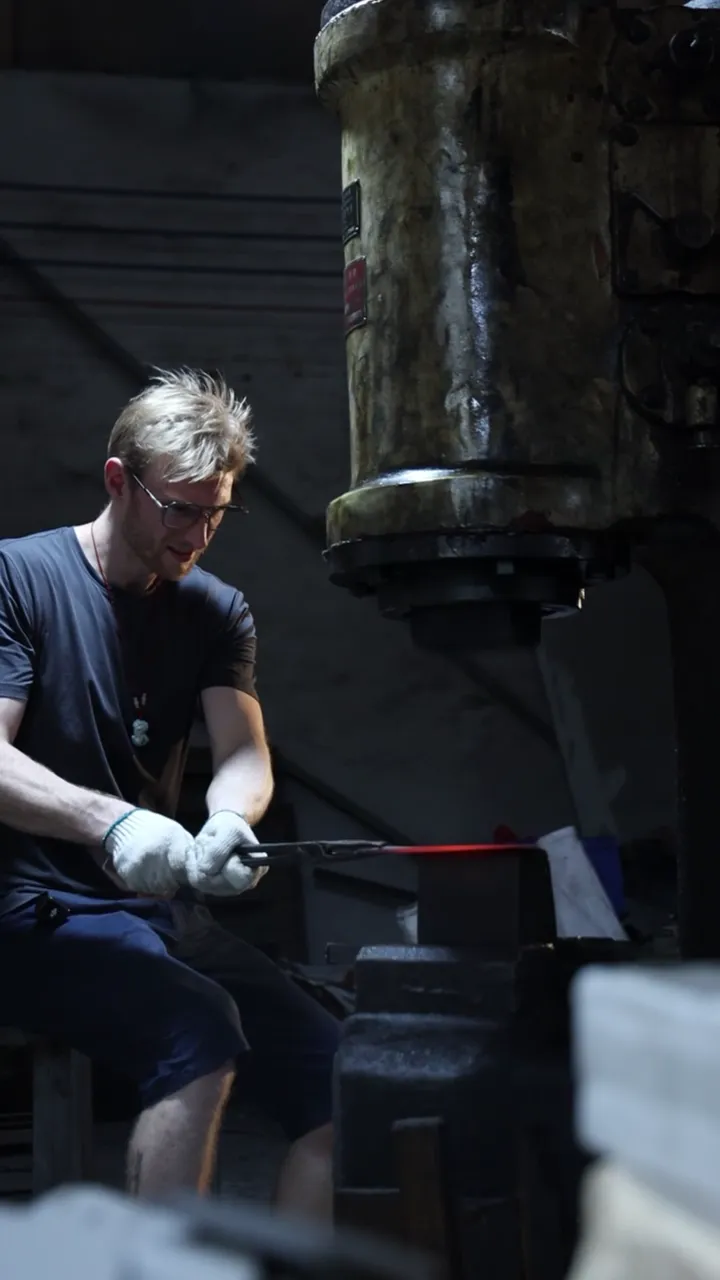 Jacob shaping hot steel under a press